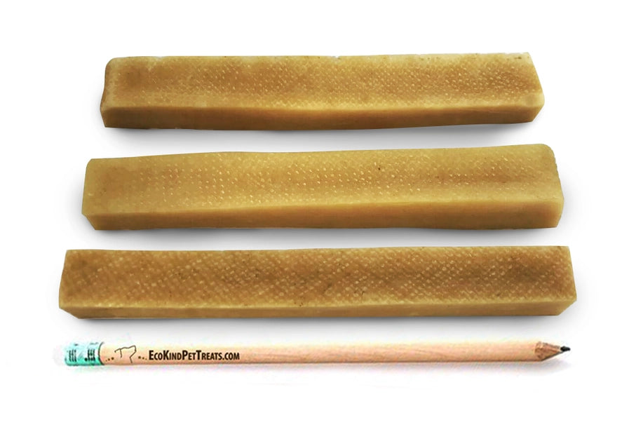 Three brown pet treats with a pencil for scale on a white background, featuring Eco King Pet Treats branding.
