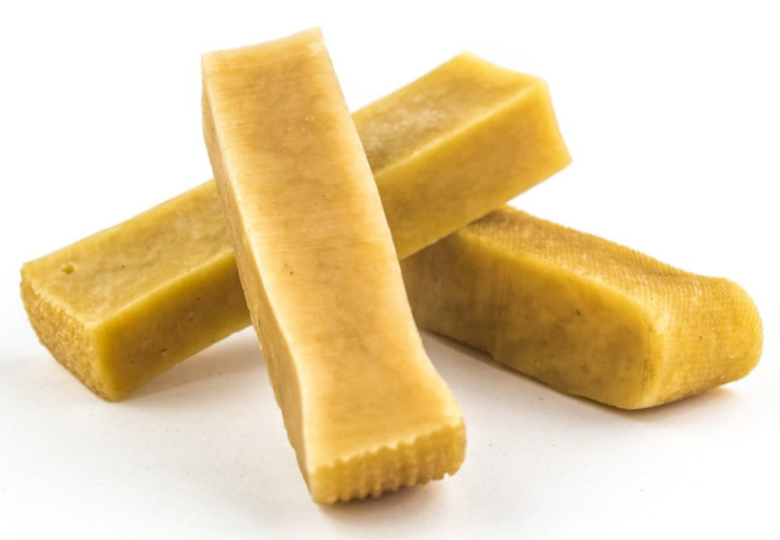 Close-up of long-lasting golden yak chews, sustainably sourced