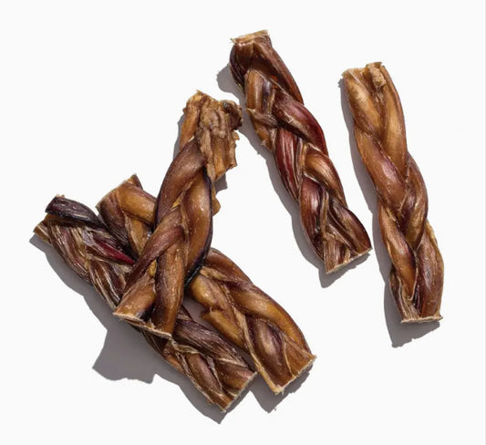 Five braided dog treats on a white background