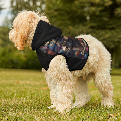 Dog wearing a black hoodie with colorful design outdoors on grass