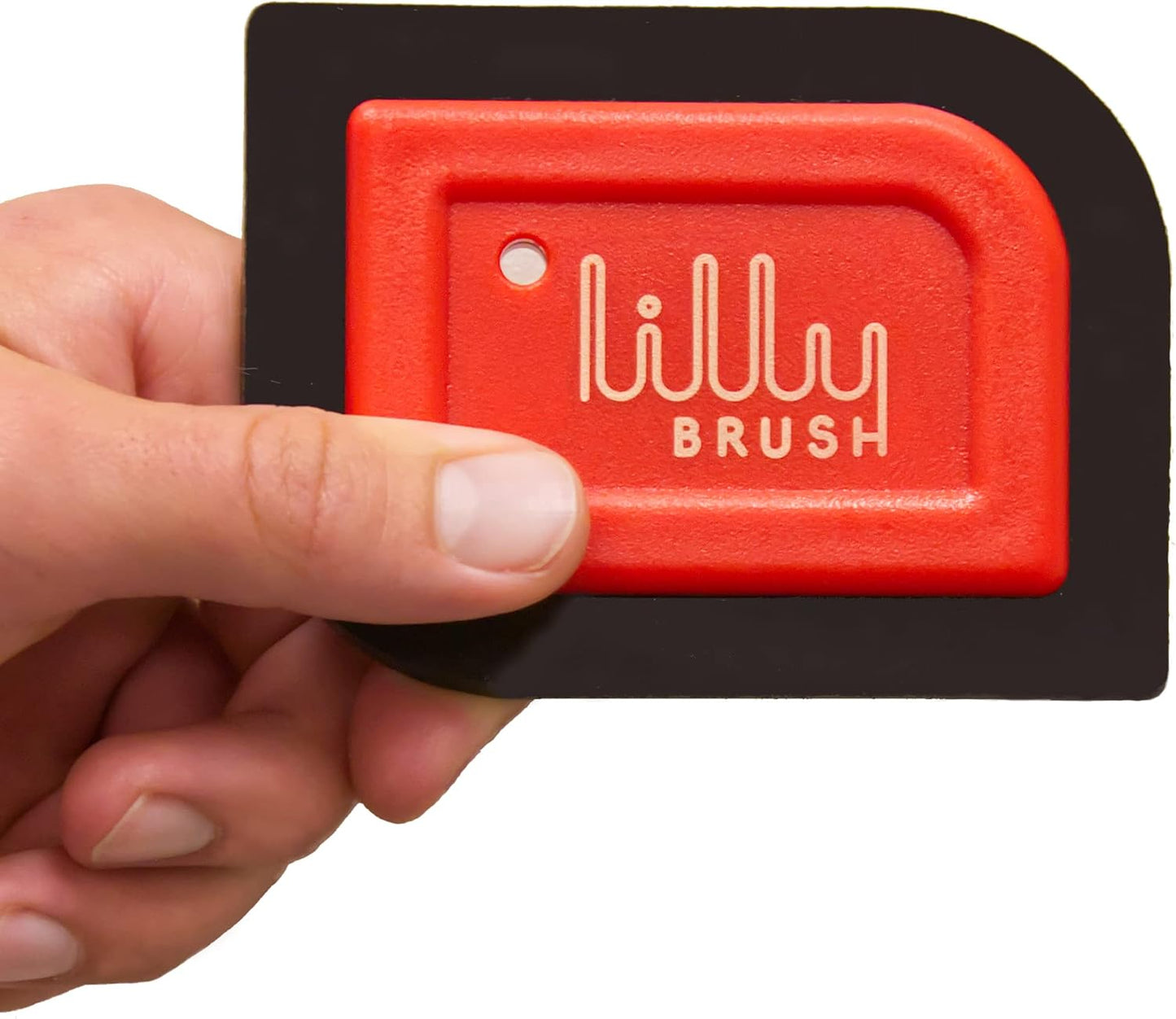 Red and black scrubber with 'lilly brush' branding held by a hand on a white background