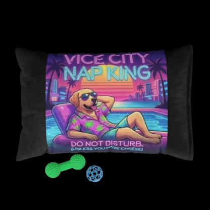 Pillow with a colorful design of a dog lounging by a pool, labeled 'Vice City Nap King', with two toys in front on a white background.