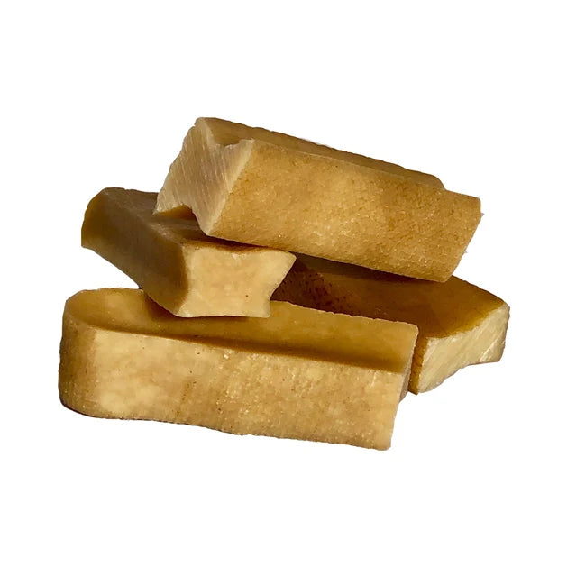 Stack of yak chews on a white background